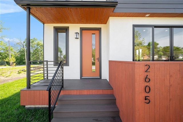 view of exterior entry with stucco siding