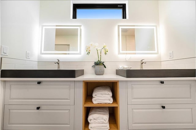 full bathroom featuring double vanity and tasteful backsplash