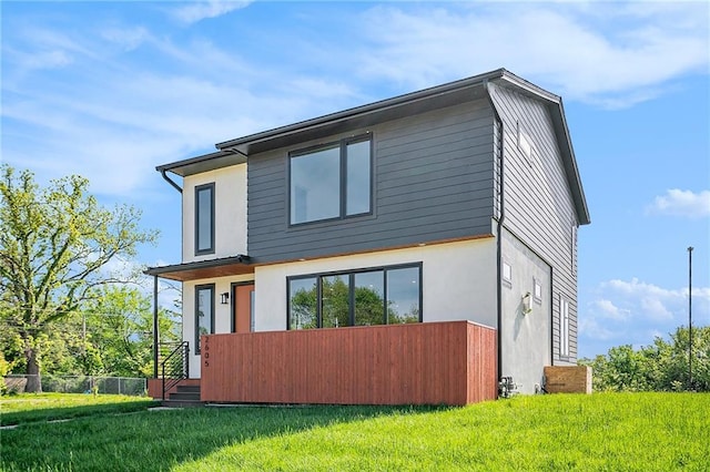 rear view of property with stucco siding