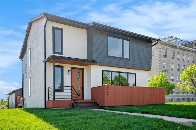 modern home with stucco siding and a front yard