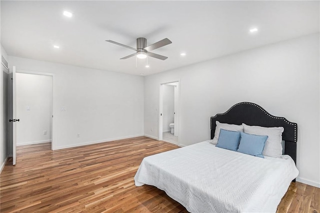 2605 W Paseo Blvd, Kansas City, MO 64108 - bedroom with wood finished floors, recessed lighting, baseboards, ensuite bath, and ceiling fan