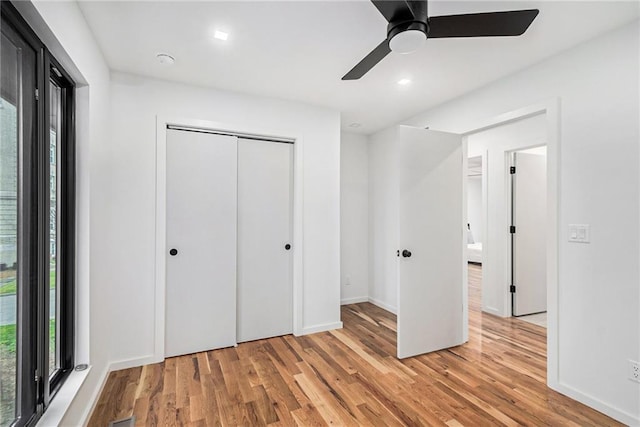 2605 W Paseo Blvd, Kansas City, MO 64108 - unfurnished bedroom with light wood-style floors, a closet, and ceiling fan