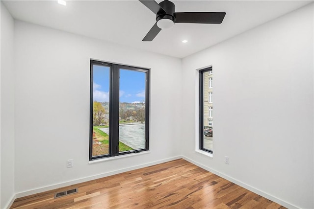 2605 W Paseo Blvd, Kansas City, MO 64108 - spare room featuring recessed lighting, baseboards, wood finished floors, and ceiling fan