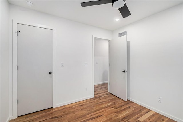 2605 W Paseo Blvd, Kansas City, MO 64108 - unfurnished bedroom featuring wood finished floors, recessed lighting, ceiling fan, and baseboards