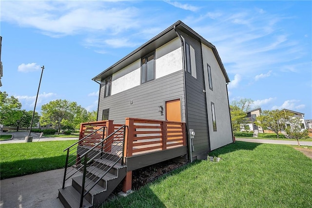 2605 W Paseo Blvd, Kansas City, MO 64108 - rear view of house with a wooden deck and a yard