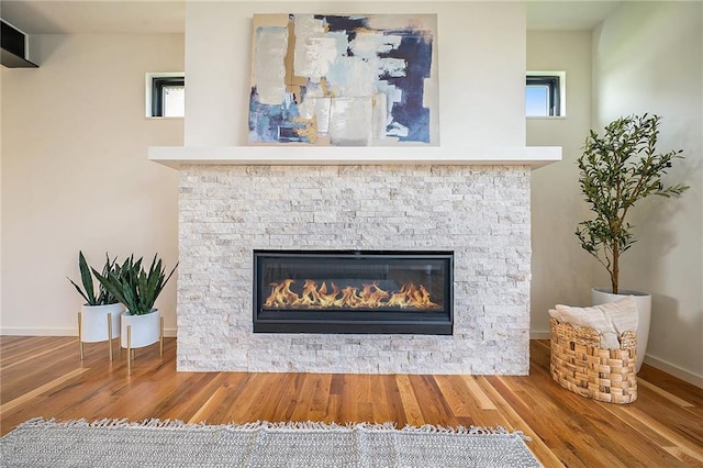 2605 W Paseo Blvd, Kansas City, MO 64108 - detailed view of wood finished floors, a stone fireplace, and baseboards