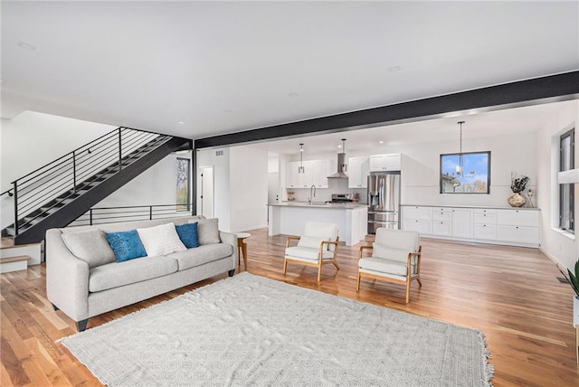 2605 W Paseo Blvd, Kansas City, MO 64108 - living area featuring light wood-style floors and stairs