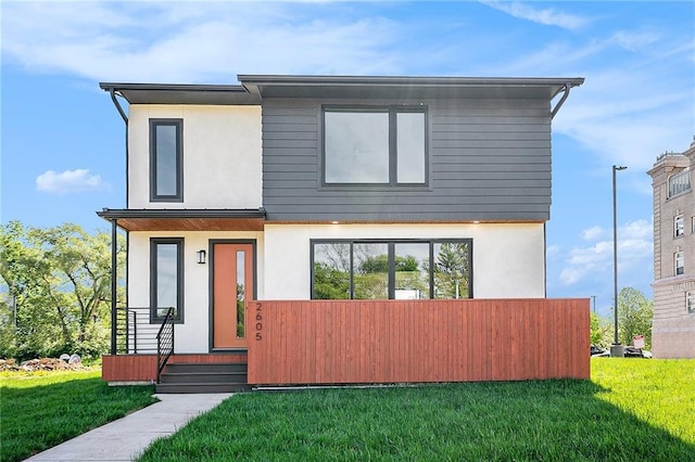 2605 W Paseo Blvd, Kansas City, MO 64108 - contemporary house with stucco siding and a front lawn
