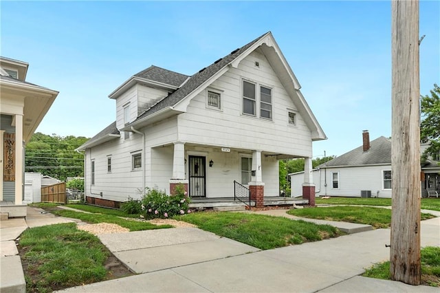 3121 Saint Joseph Ave, Saint Joseph, MO 64505 - view of front of house featuring covered porch, a front lawn, and a shingled roof