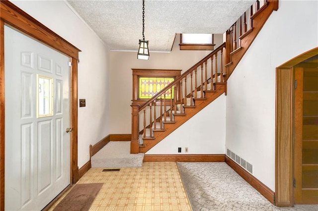 3121 Saint Joseph Ave, Saint Joseph, MO 64505 - entryway featuring carpet flooring, baseboards, a textured ceiling, and stairway