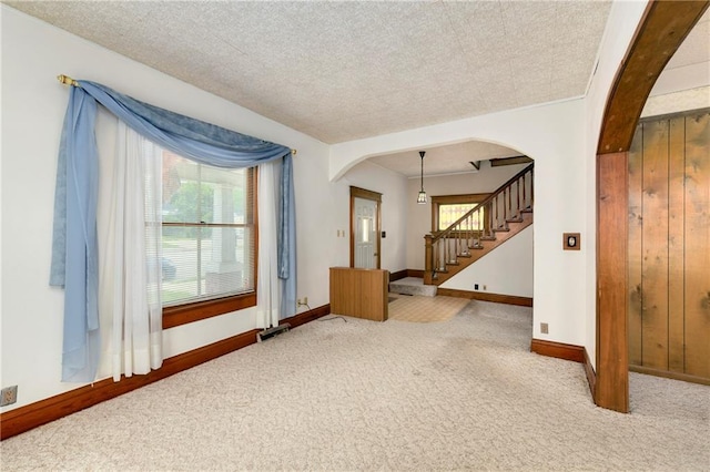 3121 Saint Joseph Ave, Saint Joseph, MO 64505 - carpeted spare room featuring arched walkways, baseboards, and stairway