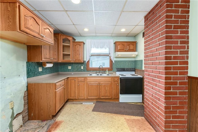3121 Saint Joseph Ave, Saint Joseph, MO 64505 - kitchen featuring range with electric cooktop, a sink, under cabinet range hood, a paneled ceiling, and brown cabinets