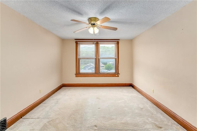 3121 Saint Joseph Ave, Saint Joseph, MO 64505 - spare room featuring a ceiling fan, light colored carpet, baseboards, and a textured ceiling