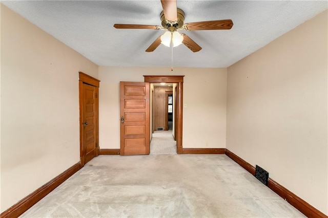 3121 Saint Joseph Ave, Saint Joseph, MO 64505 - empty room with baseboards, light colored carpet, ceiling fan, and a textured ceiling