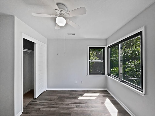 7139 Hardy St, Overland Park, KS 66204 - unfurnished bedroom featuring dark wood-type flooring, a closet, baseboards, and a ceiling fan