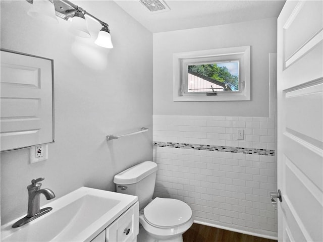 7139 Hardy St, Overland Park, KS 66204 - bathroom featuring toilet, wood finished floors, and vanity