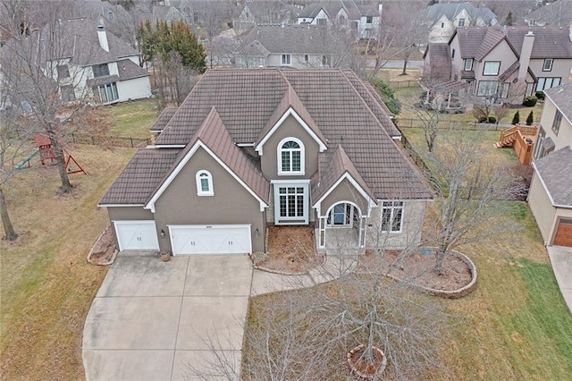 4005 W 149th St, Overland Park, KS 66224 - view of front of house featuring a tiled roof, stucco siding, driveway, a residential view, and a front lawn