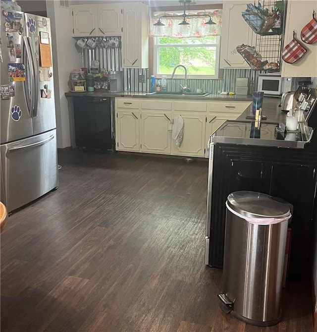 1300 S Main St, Harrisonville, MO 64701 - kitchen featuring freestanding refrigerator, a sink, dishwasher, and dark wood-type flooring