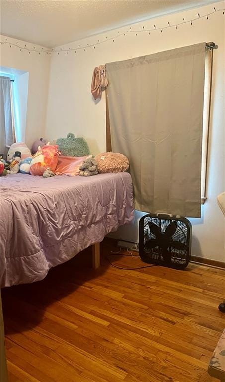 1300 S Main St, Harrisonville, MO 64701 - bedroom featuring wood-type flooring