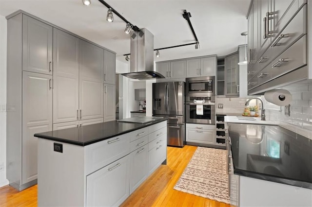9520 Lamar Ave, Overland Park, KS 66207 - kitchen featuring appliances with stainless steel finishes, island range hood, gray cabinetry, and light wood-style flooring