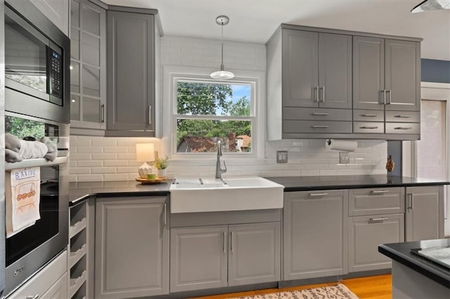 9520 Lamar Ave, Overland Park, KS 66207 - kitchen with gray cabinets, appliances with stainless steel finishes, and dark countertops