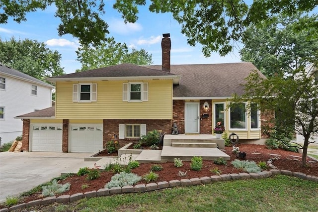 9520 Lamar Ave, Overland Park, KS 66207 - split level home with concrete driveway, brick siding, a chimney, and a garage