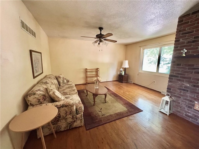 6705 E 140th Pl, Grandview, MO 64030 - living room with wood finished floors, a textured ceiling, and a ceiling fan