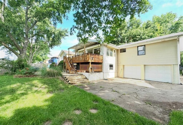 6705 E 140th Pl, Grandview, MO 64030 - rear view of house with a garage, stairway, asphalt driveway, a yard, and a wooden deck