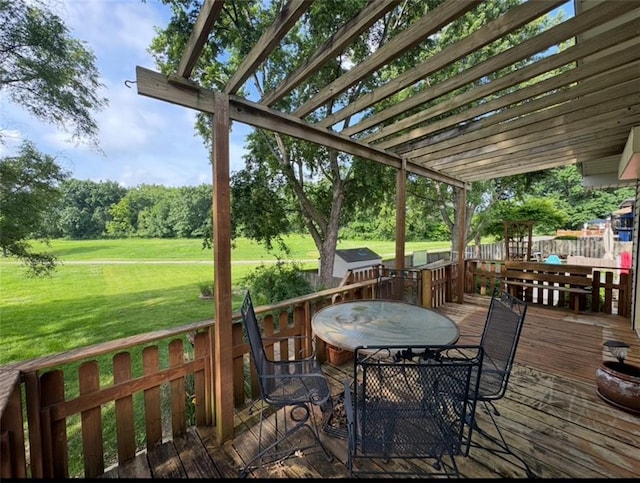 6705 E 140th Pl, Grandview, MO 64030 - wooden terrace featuring a lawn, outdoor dining area, a pergola, and view of wooded area