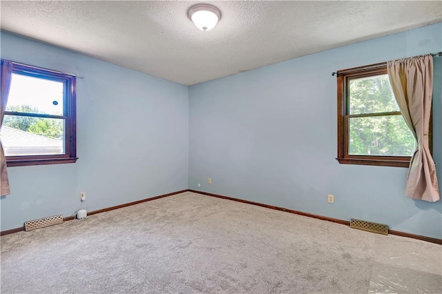 7608 N Serene Ave, Kansas City, MO 64152 - unfurnished room with a textured ceiling, carpet flooring, and baseboards