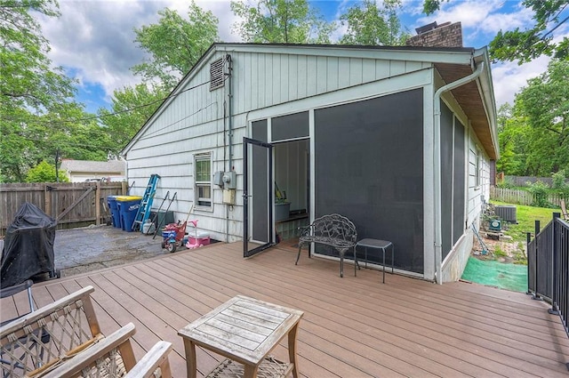 4838 Dearborn St, Mission, KS 66202 - wooden deck with a fenced backyard, central AC, and a sunroom