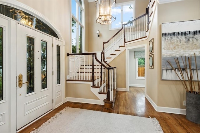 5403 Windsor Ln, Fairway, KS 66205 - entrance foyer with a chandelier, stairs, healthy amount of natural light, wood finished floors, and a high ceiling