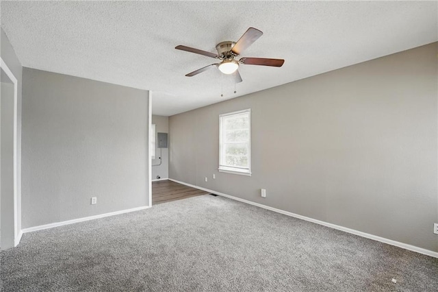 5609 E 101st St, Kansas City, MO 64137 - spare room featuring carpet flooring, a ceiling fan, baseboards, and a textured ceiling