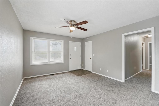 5609 E 101st St, Kansas City, MO 64137 - foyer entrance featuring ceiling fan, carpet, baseboards, and a textured ceiling