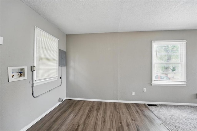 5609 E 101st St, Kansas City, MO 64137 - unfurnished room featuring wood finished floors, a textured ceiling, baseboards, and electric panel