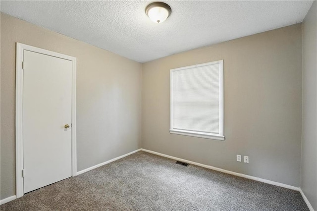 5609 E 101st St, Kansas City, MO 64137 - empty room with carpet, baseboards, and a textured ceiling