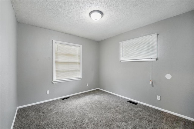 5609 E 101st St, Kansas City, MO 64137 - carpeted spare room with a textured ceiling and baseboards