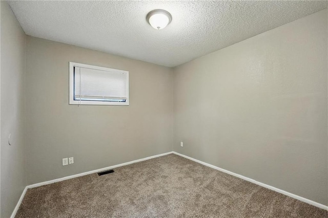5609 E 101st St, Kansas City, MO 64137 - carpeted empty room with a textured ceiling and baseboards