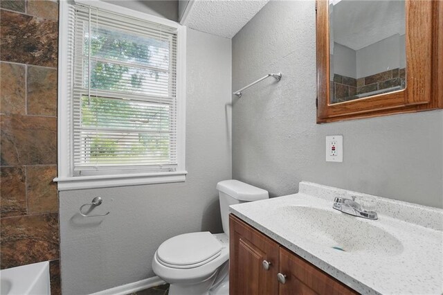 5609 E 101st St, Kansas City, MO 64137 - bathroom featuring toilet, a tub to relax in, vanity, a shower, and baseboards