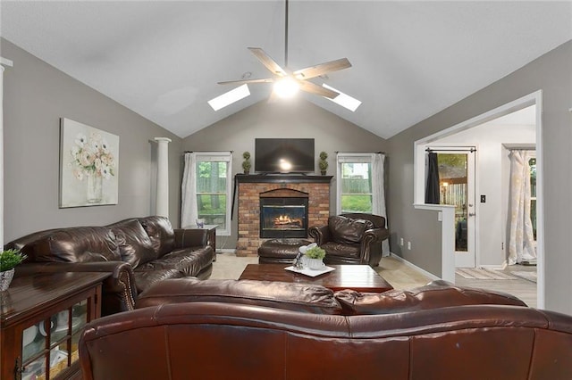 1512 Auburn Dr, Lees Summit, MO 64086 - living room with a skylight, ceiling fan, lofted ceiling, a fireplace, and baseboards