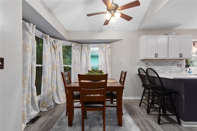 1512 Auburn Dr, Lees Summit, MO 64086 - dining area featuring vaulted ceiling, wood finished floors, ceiling fan, and baseboards