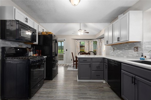 1512 Auburn Dr, Lees Summit, MO 64086 - kitchen with black appliances, a peninsula, lofted ceiling, tasteful backsplash, and gray cabinetry