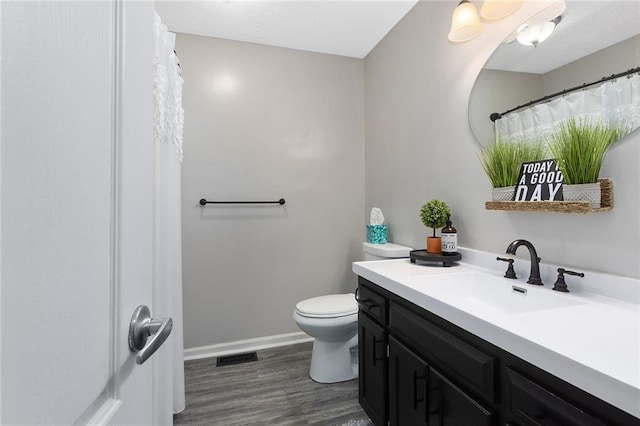 1512 Auburn Dr, Lees Summit, MO 64086 - full bath with vanity, toilet, wood finished floors, and baseboards