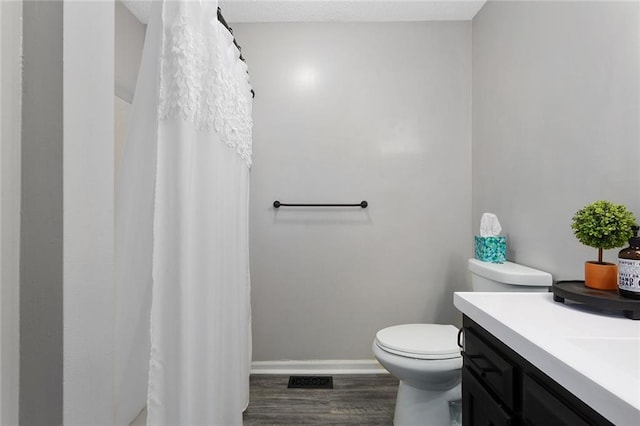 1512 Auburn Dr, Lees Summit, MO 64086 - bathroom with toilet, vanity, baseboards, and wood finished floors