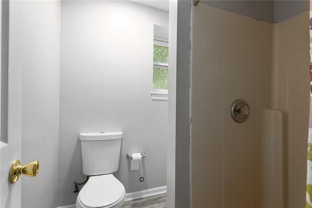 1512 Auburn Dr, Lees Summit, MO 64086 - full bathroom featuring baseboards, toilet, a shower, and wood finished floors
