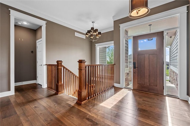 9605 N Home Ave, Kansas City, MO 64157 - foyer entrance featuring wood-type flooring, a chandelier, baseboards, and crown molding
