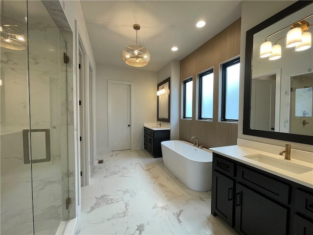 17000 Rosehill St, Overland Park, KS 66221 - bathroom with a marble finish shower, two vanities, a freestanding bath, a chandelier, and recessed lighting
