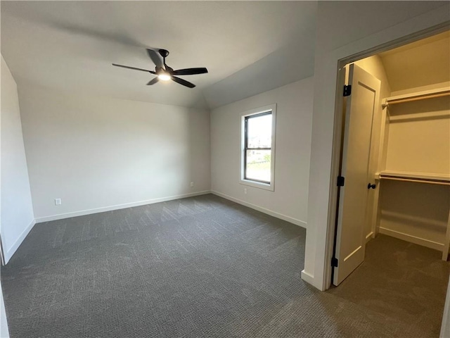17000 Rosehill St, Overland Park, KS 66221 - unfurnished bedroom featuring dark colored carpet, a walk in closet, lofted ceiling, and a ceiling fan