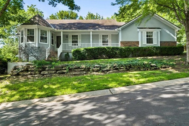 3000 Cedar Crest Dr, Independence, MO 64057 - single story home with a porch, brick siding, and a front yard
