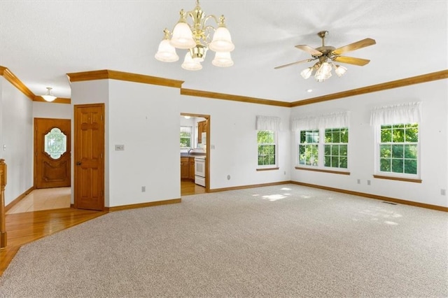 3000 Cedar Crest Dr, Independence, MO 64057 - unfurnished living room featuring crown molding, carpet flooring, plenty of natural light, baseboards, and a chandelier